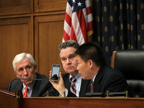WASHINGTON, DC - MAY 03:  U.S. Rep. Chris Smith (R-NJ) (2nd L), Rep. Frank Wolf (R-VA) (L) and Chinese dissident and president of ChinaAid Bob Fu (R) listen to Chinese human rights lawyer Chen Guangcheng on the phone during a hearing before the Congressional-Executive Commission on China on the blind human rights lawyer Chen Guangcheng May 3, 2012 on Capitol Hill in Washington, DC. The commission held a hearing to focus on the latest development of the escape of Chen from his house detention by local authorities and his controversial departure from the protection of U.S. Embassy in Beijing.  (Photo by Alex Wong/Getty Images)