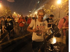 Students and their supporters brave a thunderstorm with pots and pans on Berri St. (John Kenney/The Gazette)