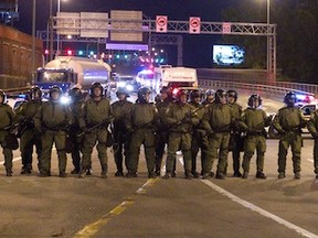 MONTREAL, QUE.: MAY 21, 2012--Surete du Quebec stand guard at the entrance to the Jacques Cartier Bridge as students and anti Bill 78 protesters take to the streets of Montreal on Monday May 21, 2012.  (Allen McInnis / THE GAZETTE)