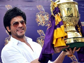Indian Bollywood actor and Indian Premier League franchise Kolkata Knight Rider?s co-owner Shah Rukh Khan poses with the IPL trophy during a press conference in Mumbai on May 30, 2012. Kolkata Knight Riders claimed victory in the annual IPL Twenty20 cricket tournament final on May 27, beating defending champions Chennai Super Kings by five wickets. (STRDEL/AFP/GettyImages)