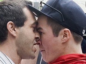 A protester (right) opposing Quebec tuition fee hikes confronts a passerby during a demonstration in Montreal, Tuesday, May 15, 2012. THE CANADIAN PRESS/Graham Hughes