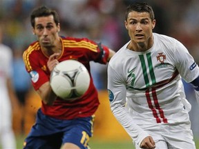 Portugal's Cristiano Ronaldo, right, and Spain's Alvaro Arbeloa run for the ball during the Euro 2012 soccer championship semifinal match between Spain and Portugal in Donetsk, Ukraine, Wednesday, June 27, 2012.
Photograph by: Matthias Schrader, AP Photo