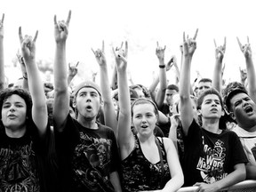 Heavy metal fans flash the genre's popular two-fingered "Sign of the horns" salute at Heavy MTL 2011. This year's edition of Heavy MTL will be held August 11-12 at Parc Jean Drapeau (Photo by Susan Moss, courtesy Evenko)