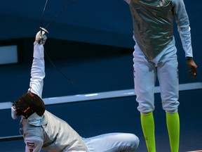 Egypt's Alaaeldin Abouelkassem (L) fences against US fencer Miles Chamley-Watson during their Men's foil bout as part of the  fencing event of London 2012 Olympic games, on July 31, 2012 at the ExCel centre in London.  AFP PHOTO / TOSHIFUMI KITAMURA