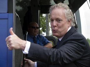 Quebec Liberal Party leader Jean Charest salutes supporters after a campaign stop Thursday, August 23, 2012 in Lachute, Que. Quebecers go to the polls Sept.4, 2012 in a provincial election. THE CANADIAN PRESS/Ryan Remiorz