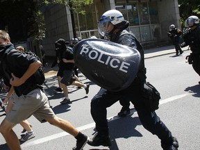 MONTREAL, QUE: AUG 8, 2012 - Students and demonstrators are chased by police along Rene Levesque Blvd in Montreal, on Wednesday, Aug 8, 2012.  (Dave Sidaway / THE GAZETTE)