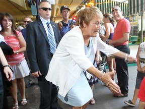 PQ leader reaches out at Atwater market during the Quebec election campaign.
