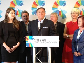 CAQ leader Francois Legault speaks to reporters in St. Lin-Laurentides on Thursday, Aug. 2, 2012. On the left is Laurence Fortin, the newly unveiled CAQ candidate in the riding of Rousseau. Photo credit: Monique Muise