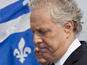 Quebec Liberal Leader Jean Charest ponders a question during a morning news conference in Quebec City on Thursday, August 9, 2012. Quebecers are going to the polls on Sept. 4. THE CANADIAN PRESS/Jacques Boissinot