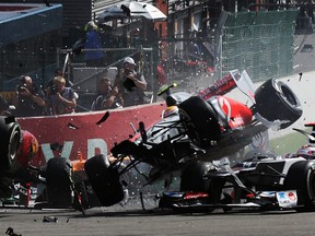 SPA, BELGIUM - SEPTEMBER 02:  Fernando Alonso (L) of Spain and Ferrari and Lewis Hamilton (R) of Great Britain and McLaren collide and crash out at the first corner at the start of the Belgian Grand Prix at the Circuit of Spa Francorchamps on September 2, 2012 in Spa Francorchamps, Belgium.  (Photo by Mark Thompson/Getty Images)