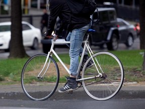 A bicycle courier rides a single speed bike as he does his rounds in Montreal on  Wednesday September 26, 2012.