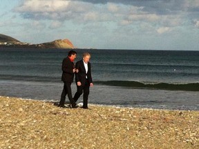 Liberal leader Jean Charest (right) speaks with Iles de la Madeleine Liberal candidate Germain Chevarie on the beach in Cap aux Meules in the Iles de la Madeleine on Saturday, Sept. 1, 2012. Photo by Max Harrold, The Gazette