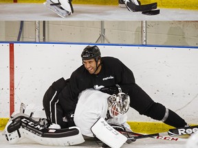 CANDIAC, QUE.: SEPTEMBER 24, 2012-- Philadelphia Flyers Maxime Talbot, rear, playfully tackles Los Angeles Kings goalie Jonathan Bernier, foreground, as they take part in a morning practice along with players from the Montreal Canadiens at Les 2 Glaces sporting centre in Candiac, south of Montreal during the NHL lockout on Monday, September 24, 2012. (Dario Ayala/THE GAZETTE)