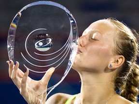 Petra Kvitova of the Czech Republic kisses her trophy after beating Li Na of China in the finals of the 2012 Rogers Cup tennis tournament  in Montreal on August 13, 2012.