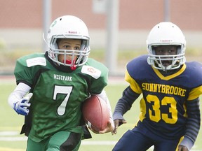 MONTREAL, QUE.: SEPTEMBER 15, 2012-- Westpark Steelers player Bradly Prent, left, runs past Sunnybrooke Bears player Mohamed Diallo, right, during a mosquito football match between the Westpark Steelers and Sunnybrooke Bears in Dollard-des-Ormeux, west of Montreal on Saturday, September 15, 2012. (Dario Ayala/THE GAZETTE)