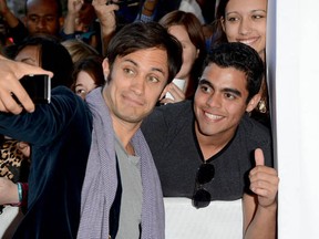 Actor Gael Garcia Bernal snaps a picture with a fan at the The Impossible premiere at the 2012 Toronto International Film Festival on September 9, 2012 in Toronto, Canada.  (Jason Merritt/Getty Images)