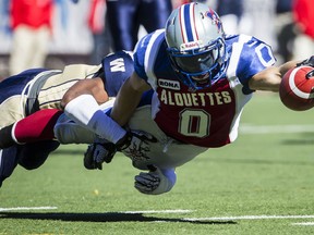 Montreal Alouettes player Bo Bowling, right, is tackled by Winnipeg Blue Bombers Brandon Stewart, left, during the first half of their CFL football match at Molson Stadium in Montreal on Monday, October 8, 2012. (Dario Ayala/THE GAZETTE)