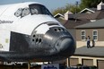 The Space Shuttle Endeavour inches its way through Crenshaw Drive, the narrowest part of its journey, as it is transported through the streets of Los Angeles on its final journey to its permanent museum home on October 13, 2012 in Los Angeles. The 170,000-pound (77,272 kg) shuttle will travel at no more than 2 mph (3.2 km per hour) along a 12-mile (19km) route from Los Angeles International Airport (LAX) to its final home at the California Science Center. NASA's space shuttle program ended in 2011 after 30 years and 135 missions.   ROBYN BECK/AFP/GettyImages