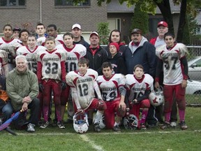 Two members of the 1962 Alexander Pee-Wee Tiger Cats, Richard Horner, 7th from left, and Norm Horner, 8th from left, join the 2012 peewee Alexander Roughriders after a game in Pierrefonds on Oct. 6.