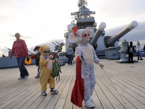 Warren and Louise Ramay wander on the deck during the fourth annual Batty Battleship Halloween Bash on the aft deck of the USS North Carolina on Tuesday, Oct. 30, 2012, in Wilmington, N.C. (AP Photo/The Star-News, Jeff Janowski)