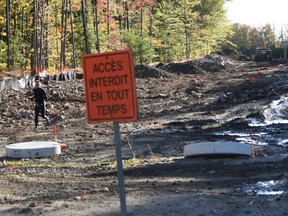 Chuck Racette runs through construction on the eventual extension of Forest Ave. in Notre Dame de l'Ile Perrot