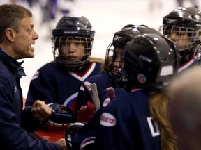 Peewee AA Selects coach Tom Handfield, left, gives a pre game talk to the team on Sunday, Oct. 28.