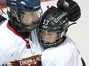 VAUDREUIL-DORION, OCTOBER 13, 2012: Trois-Lacs Aigles' Alexandre Lebel, left, celebrates with teammate Carmelo Gulloti after scoring against Deux-Rives Dauphins during their peewee AA hockey game in Vaudreuil-Dorion, west of Montreal, Saturday, October 13, 2012. [THE GAZETTE/Graham Hughes]