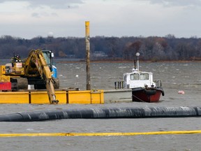 The city's new intake valve is floating on the water in Vaudreuil Bay. Workers hope windy weather doesn't cause the pipe to float away.