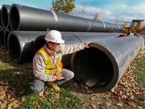 Marc Côté shows off 15-metre-long pipe segments, which will become part of the larger pipe..