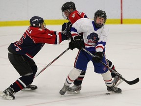 Lakeshore's Tommy Tanner avoids collision in bantam AA action.
