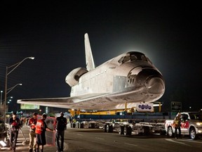 A Toyota Tundra pulls the space shuttle Endeavour across the Manchester Boulevard Bridge over Freeway 405 in Los Angeles last Friday, Oct. 12.