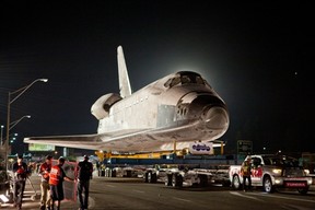 A Toyota Tundra pulls the space shuttle Endeavour across the Manchester Boulevard Bridge over Freeway 405 in Los Angeles last Friday, Oct. 12.