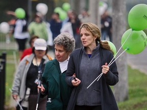 Giselle Doucet, right, and Heather Green of West Island Citizen Advocacy take part in a march to launch the West Island Community Shares annual fundraising campaign in Dollard on Oct. 4