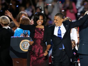 U.S. President Barack Obama stands on stage with first lady Michelle Obama after his victory speech on election night in Chicago, Illinois. We'll be following the morning after the victory at montrealgazette.com (Photo by Scott Olson/Getty Images)