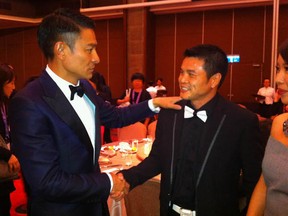 Hong Kong actor Andy Lau, left, congratulates boxing coach Qi Moxiang at the Golden Horse Awards in Yilan, Taiwan. Coach Qi appears in Chian Heavyweight, which just won the prize for best documentary. Director Yung Chang is a Montrealer.