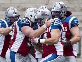 Als' Ryan Bomben is mobbed by teammates after catching TD pass against Edmonton this season.

Graham Hughes/Canadian Press