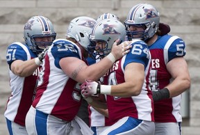 Als' Ryan Bomben is mobbed by teammates after catching TD pass against Edmonton this season.

Graham Hughes/Canadian Press