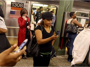 Commuters use their phones in New York's subway system. Should Montrealers be jealous?