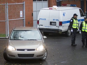 Montreal police guide a vehicle as it arrives at the department's north-end headquarters after several police agencies targeted a vast drug network across Quebec, Ontario, and British Columbia. Just one of the stories we'll be covering for you at montrealgazette.com (Dario Ayala/THE GAZETTE)