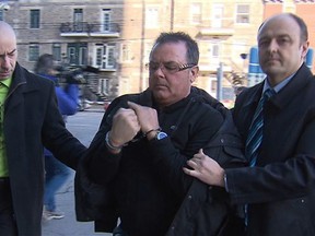 Raynald Desjardins is escorted into SQ headquarters December 20, 2011 after his arrest in connection with the shooting death of Salvatore Montagna. An attempt by Desjardins not to have to testify before the Charbonneau was quashed this week. . (Picture courtesy RADIO-CANADA)