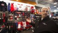 Hockey Experts assistant manager Keith Murray shows some of the licensed NHL gear in his Dollard store.