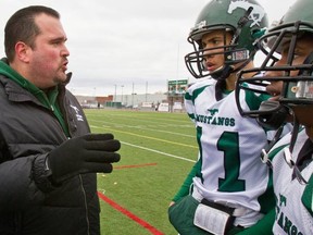 Mustangs' coach Jason Jourdenais instructs his players on the sidelines during a game.