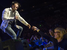 MONTREAL, QUE:  November,  5, 2012 - Arnel Pineda, lead singer of Journey reaches out to a fan during a performance at the Bell centre in Montreal, Monday, November 5, 2012 .  (Peter McCabe / THE GAZETTE)