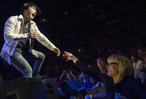 MONTREAL, QUE:  November,  5, 2012 - Arnel Pineda, lead singer of Journey reaches out to a fan during a performance at the Bell centre in Montreal, Monday, November 5, 2012 .  (Peter McCabe / THE GAZETTE)