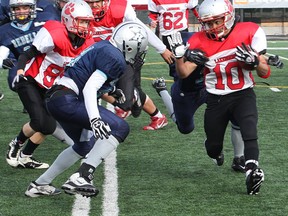 Lakeshore ball carrier Cordell Ramsay, right, tries to break a tackle from behind by the Rebelles defence.