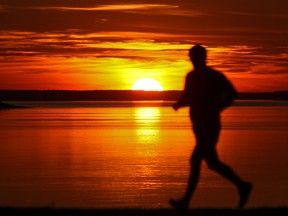 A man runs on St. Joseph Blvd. as the sun sets in the Lachine borough of Montreal Wednesday, November 14, 2012.     (John Mahoney/THE GAZETTE)