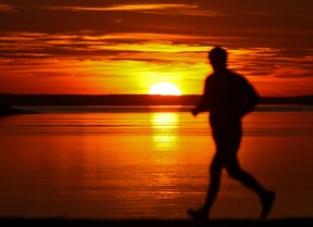 A man runs on St. Joseph Blvd. as the sun sets in the Lachine borough of Montreal Wednesday, November 14, 2012.     (John Mahoney/THE GAZETTE)