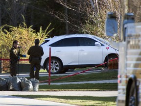 Police investigators examine the crime scene where alleged mob boss Joseph Di Maulo was murdered Sunday night in front of his home in Blainville.THE CANADIAN PRESS/Ryan Remiorz