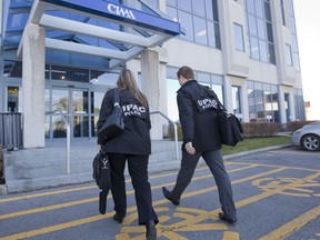 UPAC police officers enter the offices of Cima Plus, in Laval on Tuesday November 6, 2012.  The raid is just one of the stories we're following for you at montrealgazette.com ( Phil Carpenter/THE GAZETTE)