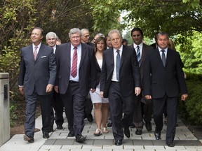 The last round up. Quebec Liberal Party Leader Jean Charest, walks with candidates, on his way to his office following a news conference Tuesday, August 14, 2012 in Quebec City. Three weeks later the Liberals would lose the election and Charest his seat in Sherbrooke. THE CANADIAN PRESS/Jacques Boissinot